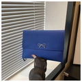 Detail of navy blue envelope clutch with silver metal bow and detachable strap - Blue