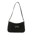 Chic black leather underarm bag with a bold gold bow metal buckle in a sleek baguette style - Black