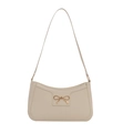 Minimalist beige baguette shoulder bag featuring a decorative golden metal bow on the front - White