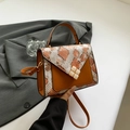 Brown leather crossbody bag featuring snakeskin pattern flap and gold square lock - Brown