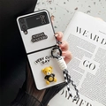 Detail of white leather phone case for Samsung Z Flip with cute bear charm and hand strap - Cross Texture Smiley Bear Wrist Strap White / Samsung ZFlip3