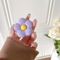Purple flower collapsible phone grip held in hand with yellow center and matte finish - Matte Purple Flower