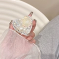 Detail of heart-shaped phone grip with resin rose flower and sparkling rhinestones - White