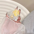 Macro shot of a heart-shaped phone grip with yellow resin rose and pearls - Yellow