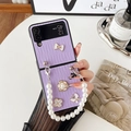 Detail of purple folding phone case with pearl strap and floral charms for Galaxy Z Flip - Purple / Samsung ZFlip3