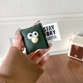 Close-up of cute plush green pillow phone grip with big eyes and a branded textile label - Green