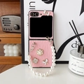 Detail of pink leather texture phone case with pearl chain and floral charms on a desk - Pink / Samsung ZFlip3