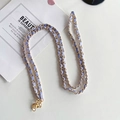Close-up of gold metal chain with lavender leather strap and secure lobster clasp - Light Purple
