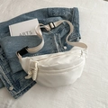 Minimalist white canvas waist bag with adjustable strap and buckle on blue denim - White