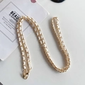Close-up of a luxury gold metal and white leather interwoven crossbody phone chain strap - White