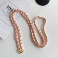 Detail of pink leather woven with gold metal chain strap featuring sturdy lobster clasps - Pink