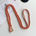 Detail of red leather woven with gold metal chain featuring secure lobster clasps - Red