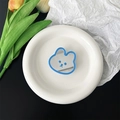 Close-up of cute blue bear mirror phone grip on white tray with decorative tulips - Blue