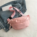 Minimalist pink nylon sports waist bag with woven rope zippers on denim backdrop - Pink