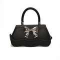 Black stylish handbag with silver metal bow and wavy bottom edge on white background - Black