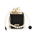 Minimalist black drawstring bucket bag with large pearl handle and striped texture detail - Black
