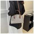 Vintage quilted shell bag with leather straps shown in a modern lifestyle setting - Coffee
