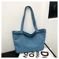 Minimalist blue denim tote bag with long shoulder straps on a clean lifestyle background - Blue