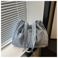 Detail of light blue denim tote bag with drawstring closure and front large pocket - Sky Blue