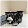 Detail of black tote bag with colorful embroidery and white cloud plush charm detail - With Charm / Black