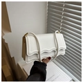Detail of white scalloped edge shoulder bag with gold hardware and tiered structure - White