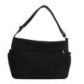 Borsa tote grande in tela nera con tracolla regolabile e tasche laterali su sfondo bianco - Nero