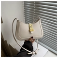 Detail of off-white shoulder bag with golden geometric clasp and knotted leather strap - White