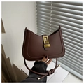 Detailed close-up of dark reddish-brown leather shoulder bag with gold geometric clasp - Dark Brown