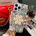 Luxurious rhinestone iPhone case with 3D pearl flowers and sparkling gems held by hand - Rhinestone Flower White / iPhone 15 Pro Max