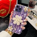 Luxury iPhone case with purple crystals and pearl floral ornaments in hand - Rhinestone Flower Purple / iPhone 15 Pro Max