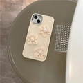 Detail view of cream silicone iPhone case featuring 3D lace flowers and pearl embellishments - iPhone 7/8/SE 2020 / Apricot