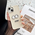 Detailed close-up of the beige silicone phone case featuring cartoon eyes and Hello badge - Apricot (Electroplated Frame-Hello Eyes) / iPhone 7/8/SE 2020