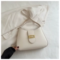 Detail of a creamy white half-moon shoulder bag with a sleek gold rectangular metal buckle - White