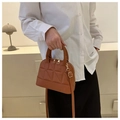 Compact brown quilted shell crossbody bag with dual handles and golden zipper detail - Brown
