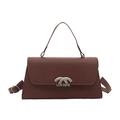 Deep brown leather crossbody bag with silver curved metal buckle and top handle - Brown