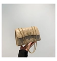 Detail shot of a beige quilted crossbody bag with golden clasp and chain strap - Khaki
