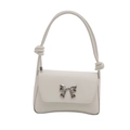 White faux leather shoulder bag with a silver bow buckle and knotted strap detail - White