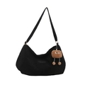 Black canvas tote bag with a brown plush monster charm and adjustable shoulder strap - Black with Pendant