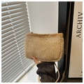 Detail of straw woven crossbody bag featuring light beige fiber texture and brown leather strap - Khaki
