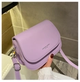 Detailed close-up of light purple PU leather saddle bag with silver hardware and logo - Purple