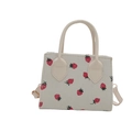 Off-white corduroy tote bag featuring red strawberry prints and golden metal buckles - White Strawberry Print / White