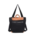 Black canvas tote bag with brown leather trim and Light Fashion print on white background - Black