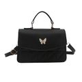Quilted black crossbody bag with butterfly hardware and geometric pattern detail - Black
