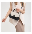 Detail of contrast stitching and woven texture on this stylish crossbody bag for women - Black