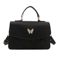 Elegant black quilted crossbody bag featuring a white butterfly ornament and top handle - Black