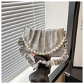 Detail of light gray pleated handbag featuring stone texture and large pearl handle chain - Silver