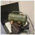 Detail of dark green pillow bag with golden turn-lock buckles and patterned wide strap - Green