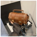Detail of retro brown Boston bag with wavy stitching and ethnic patterned wide strap - Brown