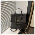 Detail of black pleated faux leather shoulder bag with a silver metallic twist-lock closure - Black