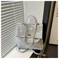 Detail of silver metallic wrinkled texture and oval metal twist lock on the casual backpack - Silver